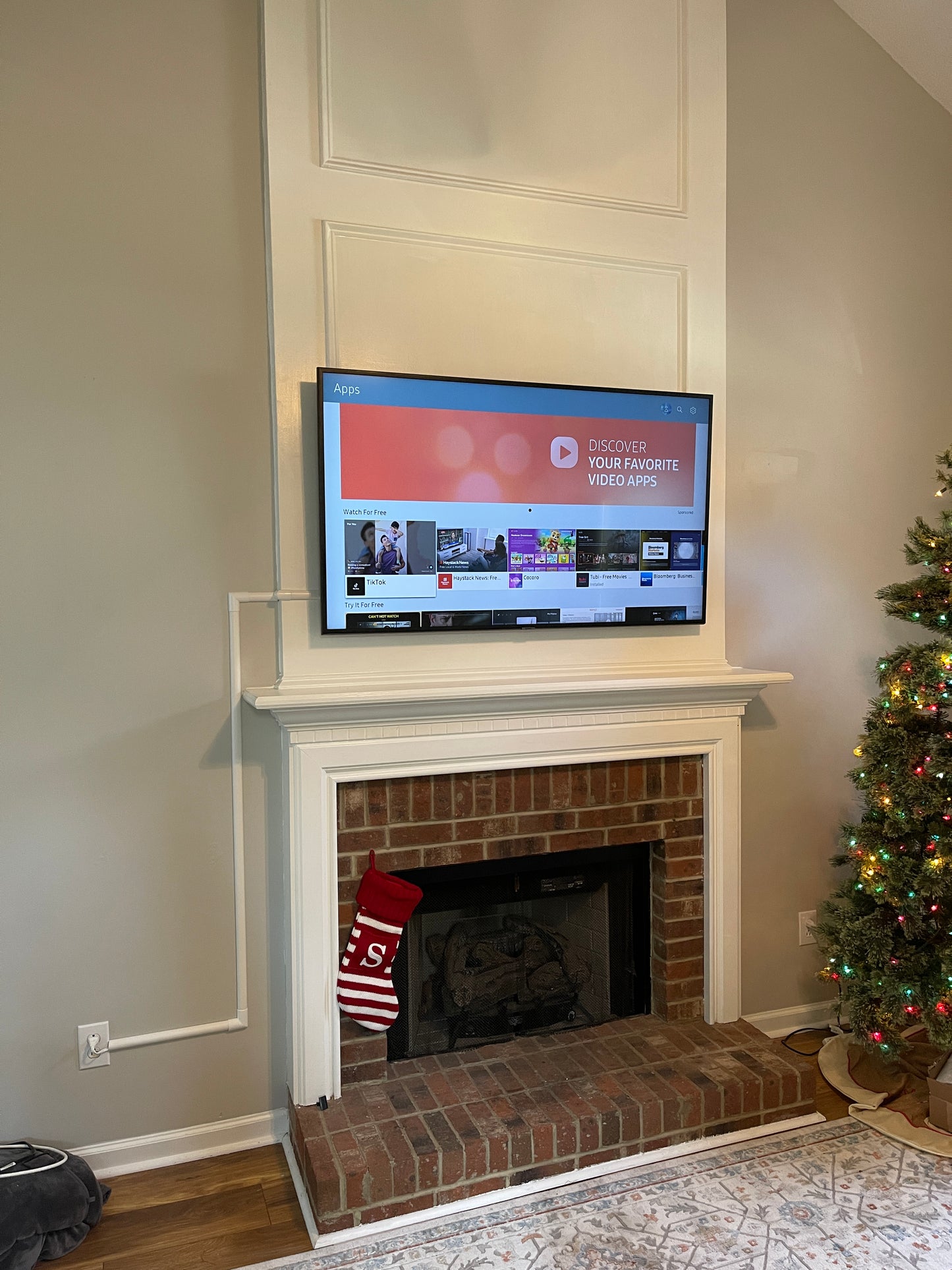 best tv mounting rdu, tv mounted on white wall over fireplace